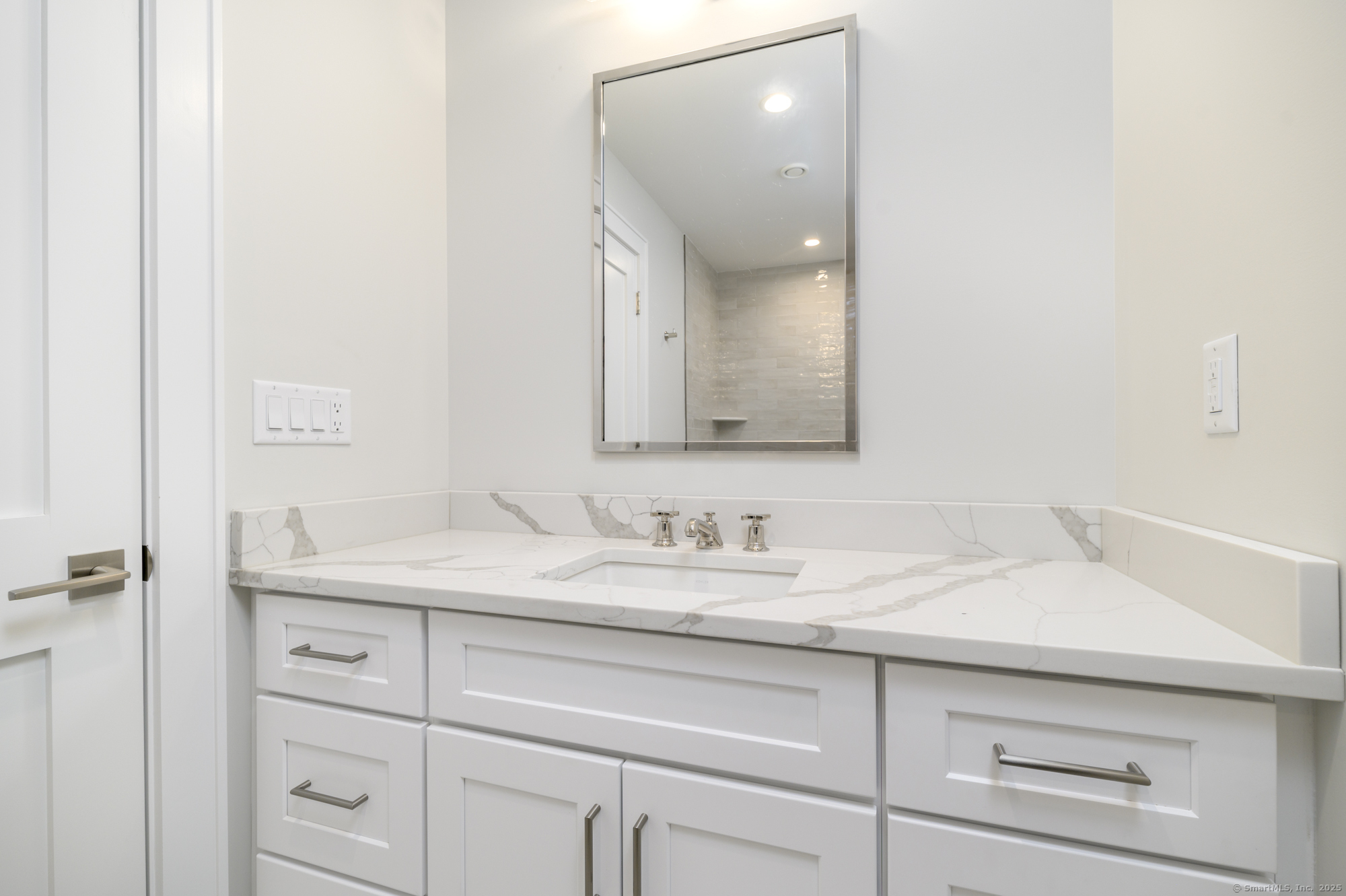 40 Hoyclo Road Stamford, CT 06903 - Photo 28 of 38 a bathroom with a sink and a mirror