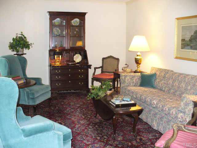 6900 Buckhead Drive Raleigh, NC 27615 - Photo 3 of 10 a living room with furniture a table and a painting on the wall