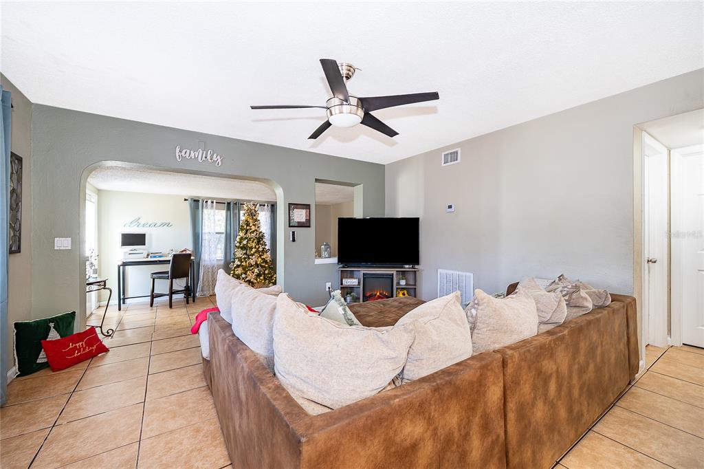 944 Halstead Street Deltona, FL 32725 - Photo 17 of 28 a living room with furniture and a flat screen tv