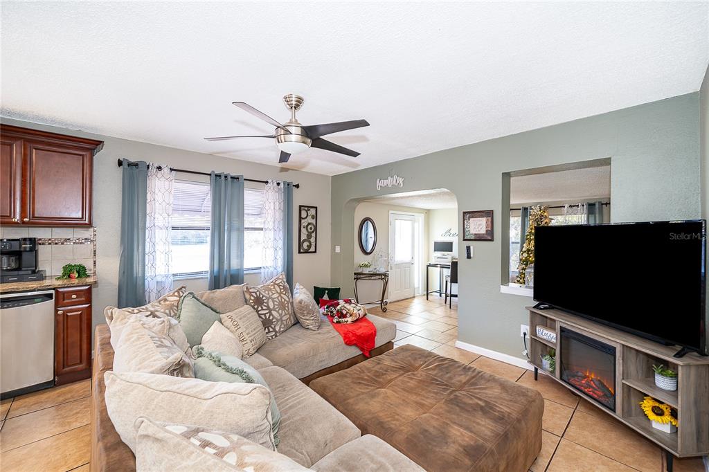 944 Halstead Street Deltona, FL 32725 - Photo 18 of 28 a living room with furniture and a flat screen tv