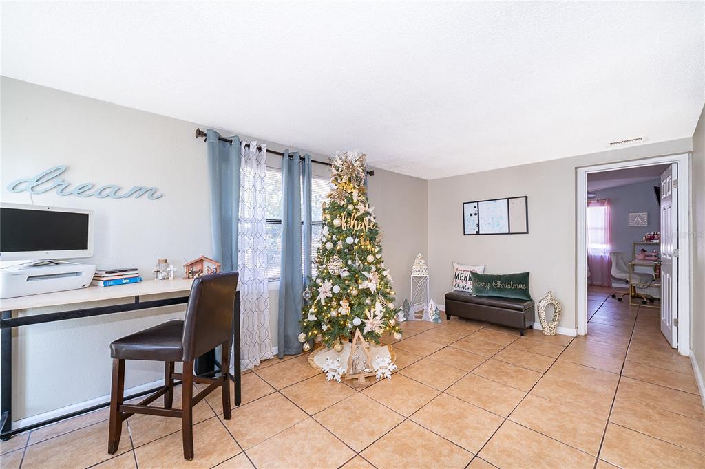 944 Halstead Street Deltona, FL 32725 - Photo 19 of 28 a room with furniture and a potted plant