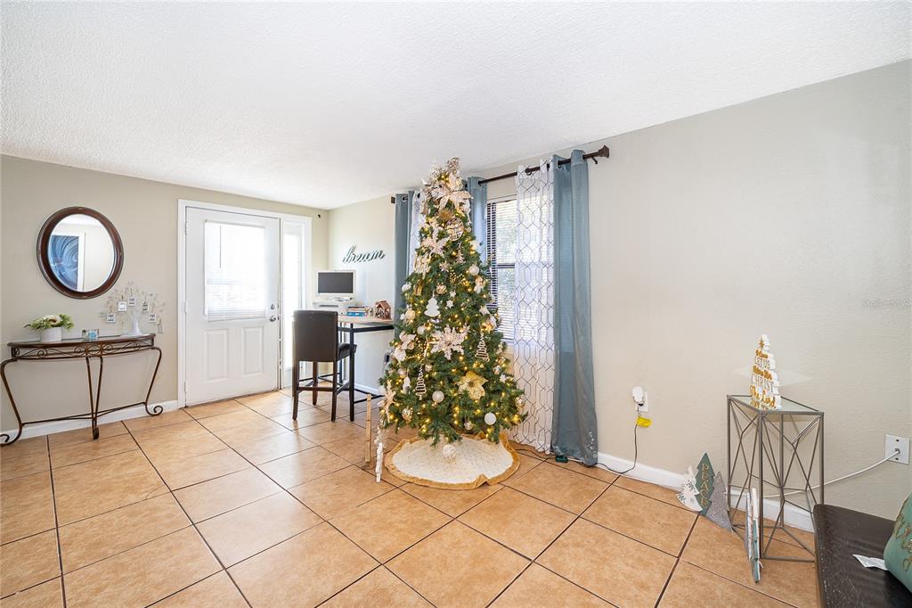 944 Halstead Street Deltona, FL 32725 - Photo 22 of 28 a living room with furniture and a potted plant