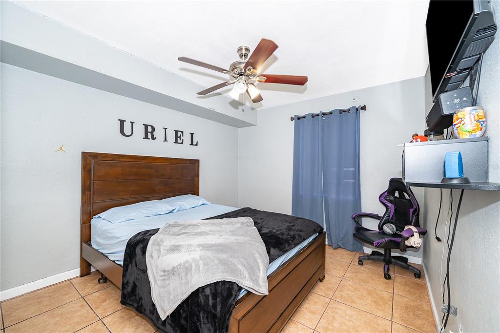 944 Halstead Street Deltona, FL 32725 - Photo 24 of 28 a bedroom with a bed and furniture