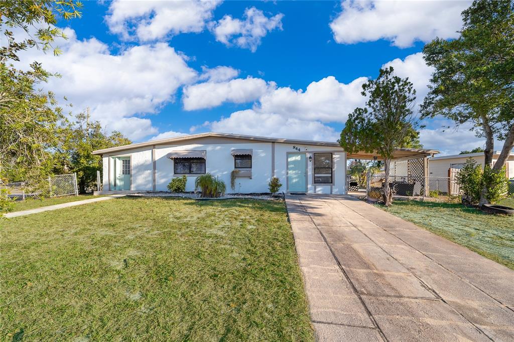 944 Halstead Street Deltona, FL 32725 - Photo 6 of 28 a front view of a house with a garden