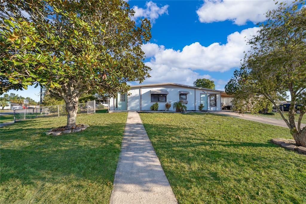 944 Halstead Street Deltona, FL 32725 - Photo 7 of 28 a front view of a house with a yard