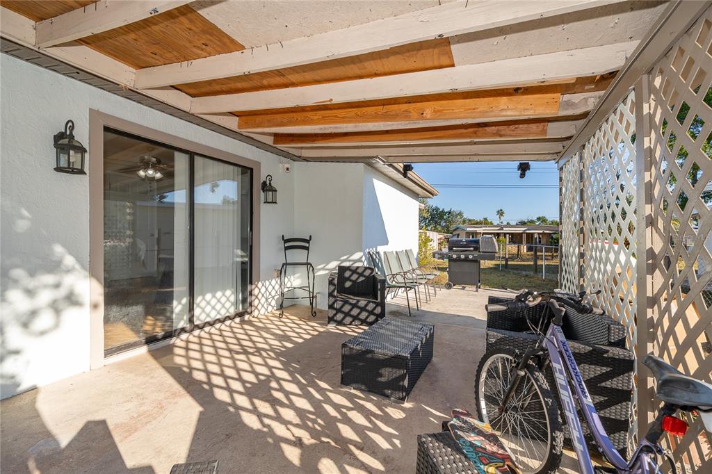 944 Halstead Street Deltona, FL 32725 - Photo 8 of 28 a room with lots of chairs and a chandelier