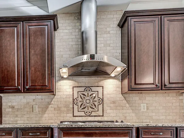 a kitchen with granite countertop cabinets and black appliances