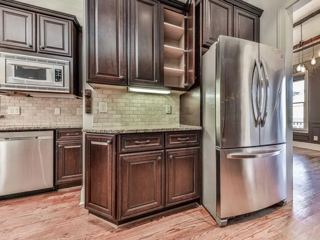 a kitchen with granite countertop stainless steel appliances and wooden cabinets
