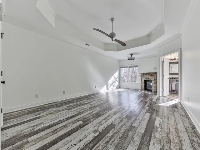 wooden floor in an empty room with a fireplace