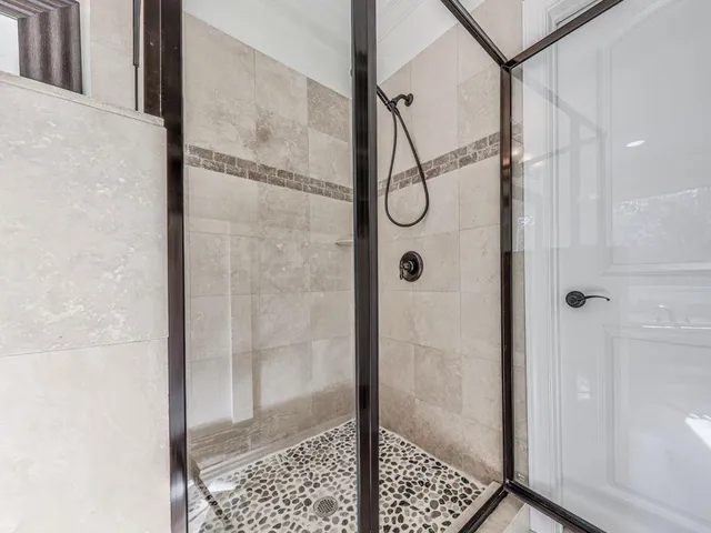 a bathroom with a glass shower door