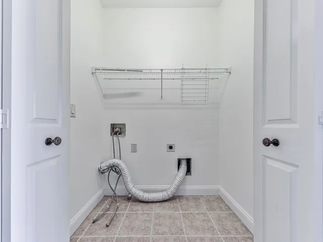 a view of a livingroom with a flesh screen tv and stairs