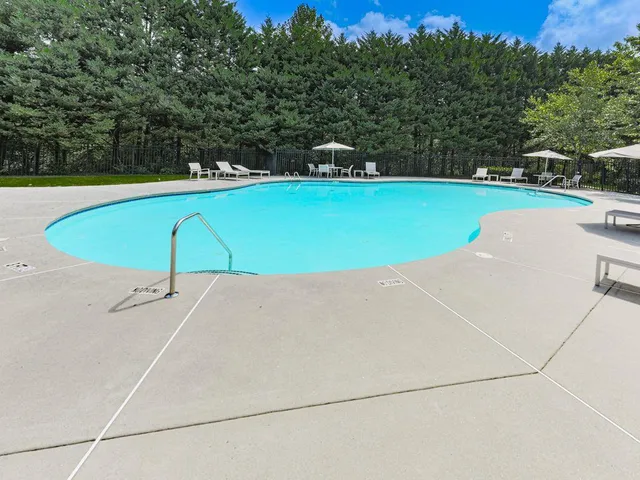 a street sign on a sidewalk next to a road