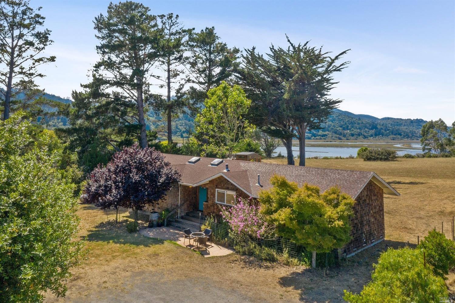 260 Mesa Road Point Reyes Station, CA 94956 - Photo 1 of 1 a view of a lake with a mountain in front of it