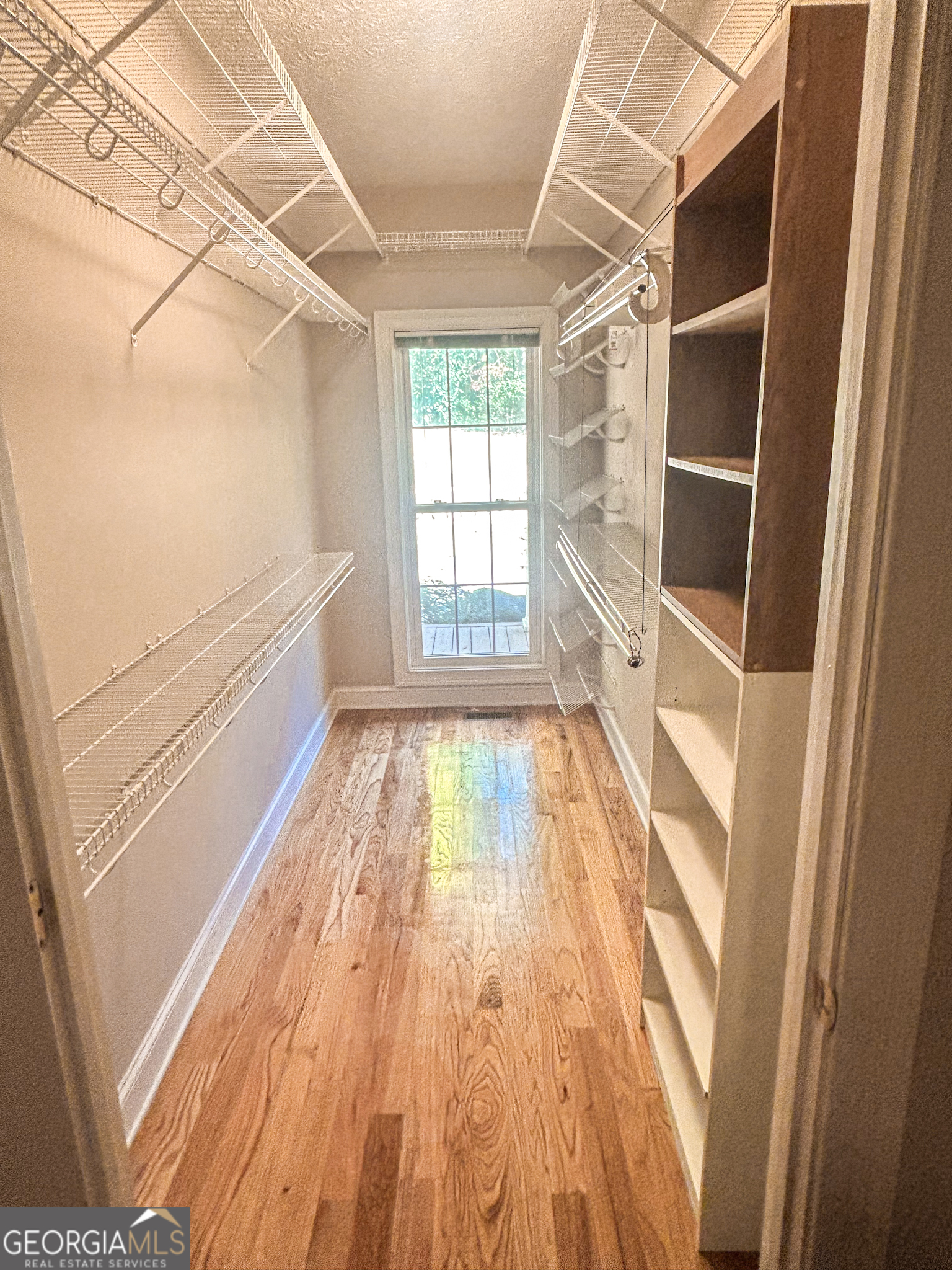 1136 Cole Lake Road Dallas, GA 30157 - Photo 24 of 57 a view of empty room with wooden floor and fan