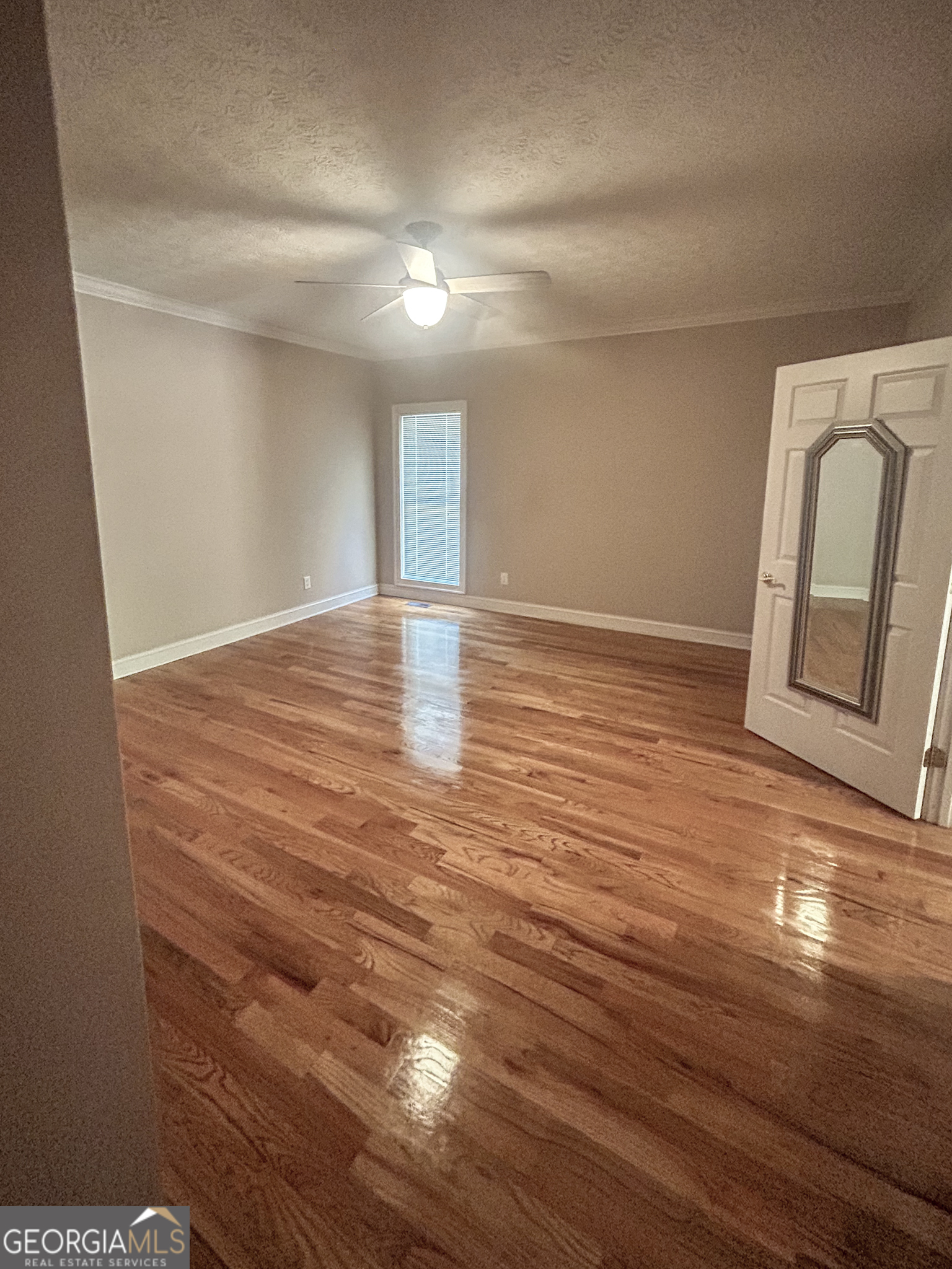 1136 Cole Lake Road Dallas, GA 30157 - Photo 25 of 57 a view of an empty room with wooden floor and a window