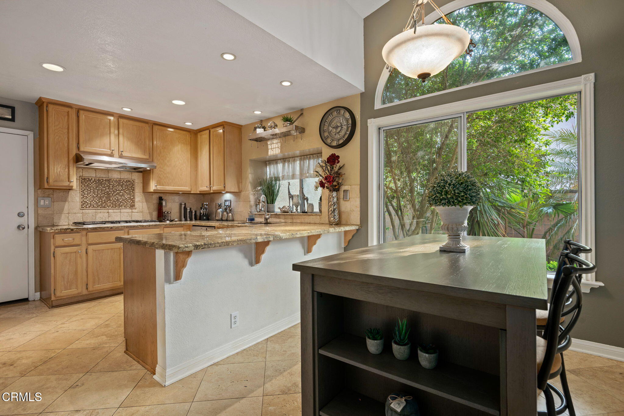 1501 Devonshire Drive Oxnard, CA 93030 - Photo 13 of 39 a kitchen with a table chairs microwave and cabinets