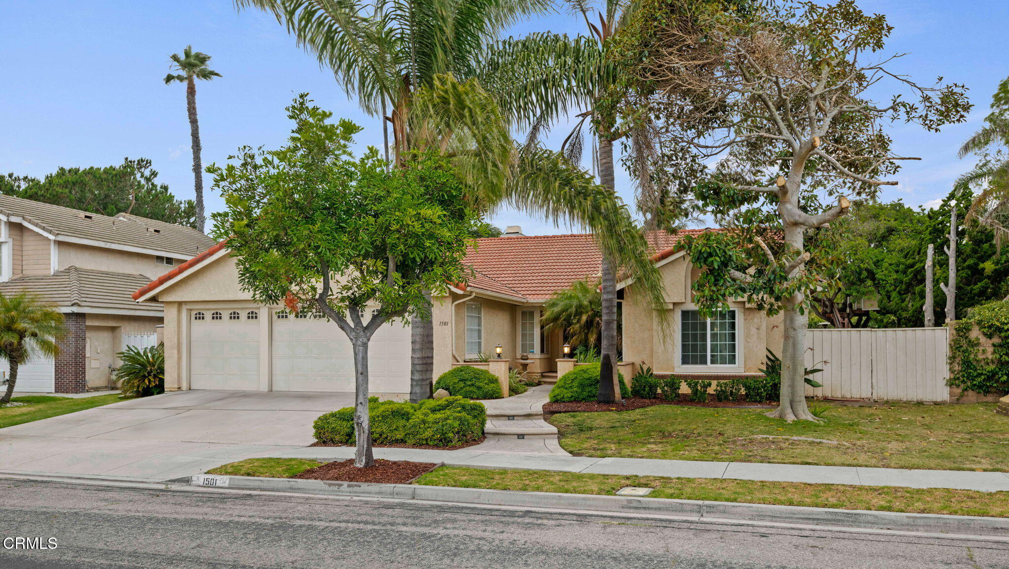 1501 Devonshire Drive Oxnard, CA 93030 - Photo 2 of 39 a front view of a house with a garden and tree