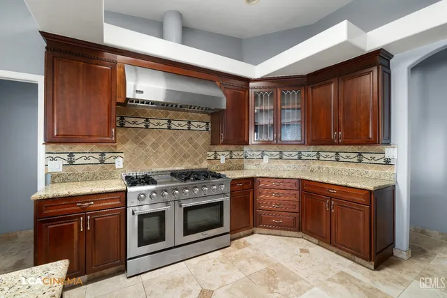 a kitchen with stainless steel appliances granite countertop a stove and a sink