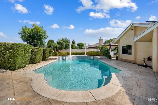 a view of a swimming pool with a yard