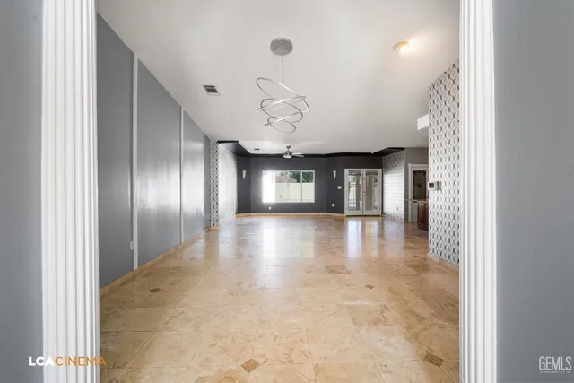 a view of a hallway with chandelier and entryway