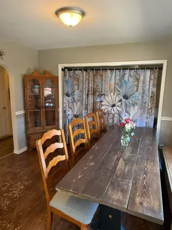 a view of a dining room with furniture and a window
