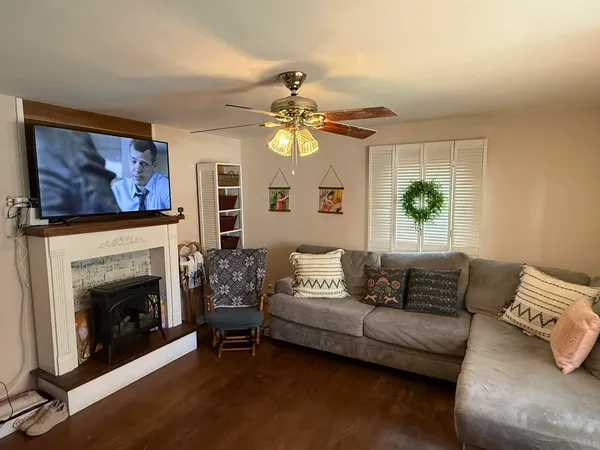 a living room with furniture a chandelier and a window