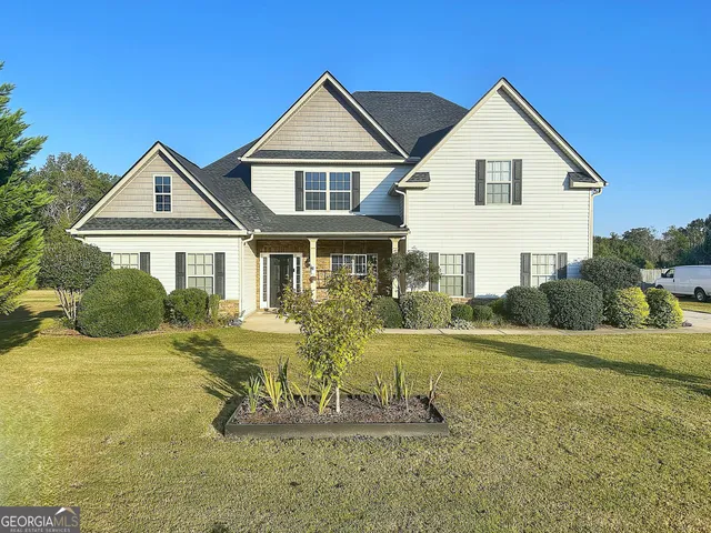 a view of a house with a yard patio and fire pit