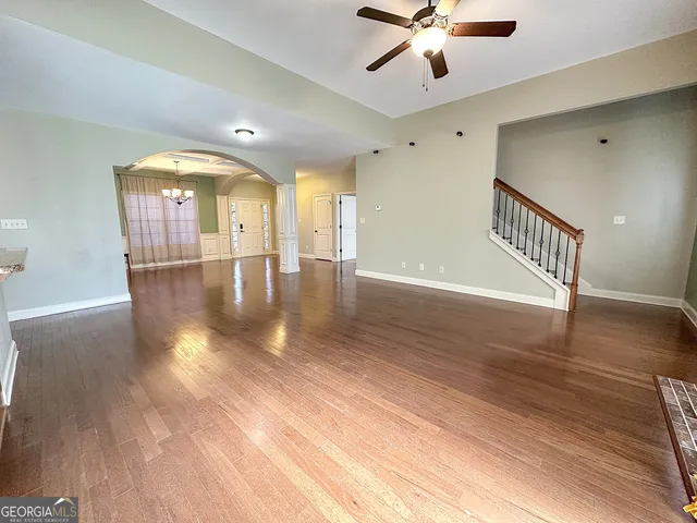 a view of a kitchen with a sink wooden cabinets and a window
