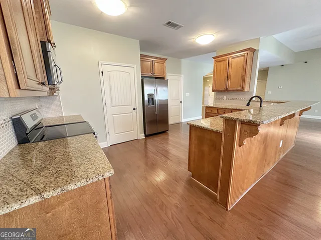 a bathroom with a sink and mirror with toilet