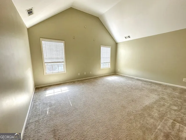 a view of an empty room and a window