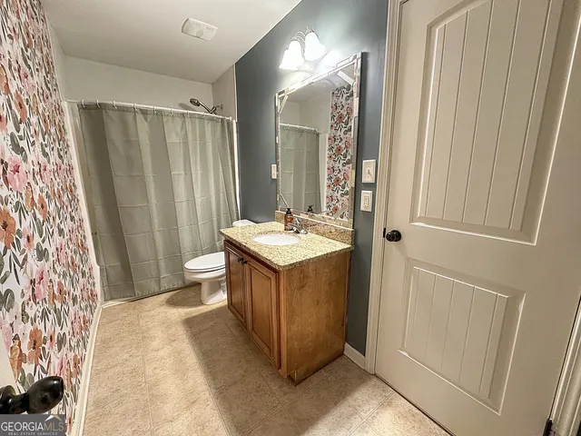 an empty room with a ceiling fan and a window