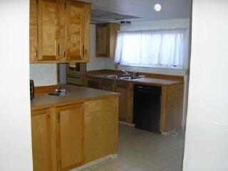 110 Sage Trail Road, Unit 11 Yakima, WA 98901 - Photo 8 of 11 a kitchen with a sink and a refrigerator