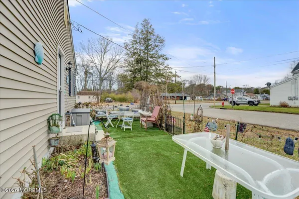 a view of a chair and tables in the backyard