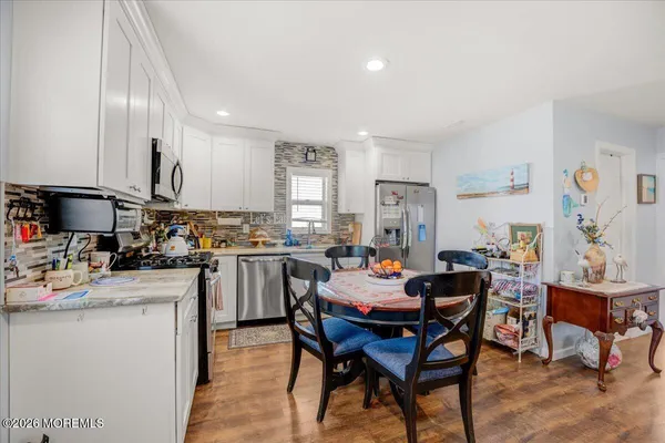 a kitchen with a table chairs sink and cabinets