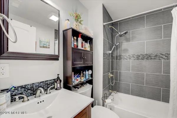 a bathroom with a bathtub and a shower