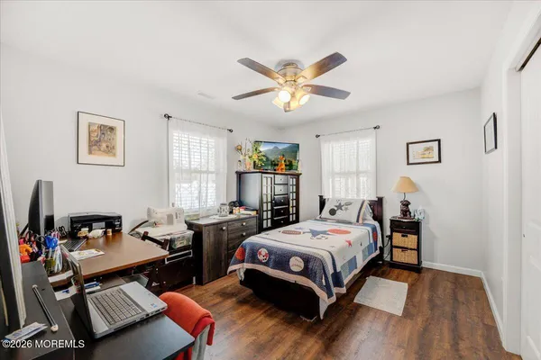 a bedroom with a bed gym equipment and a window