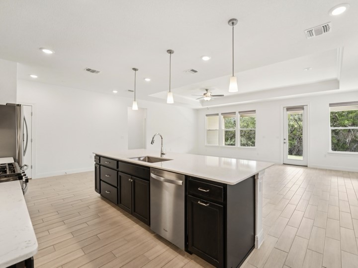 312 Kitty Hawk Road Georgetown, TX 78633 - Photo 35 of 37 a kitchen with a sink a window and stainless steel appliances