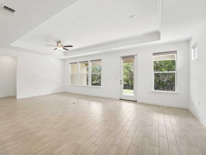 312 Kitty Hawk Road Georgetown, TX 78633 - Photo 12 of 37 a view of an empty room with a window and wooden floor