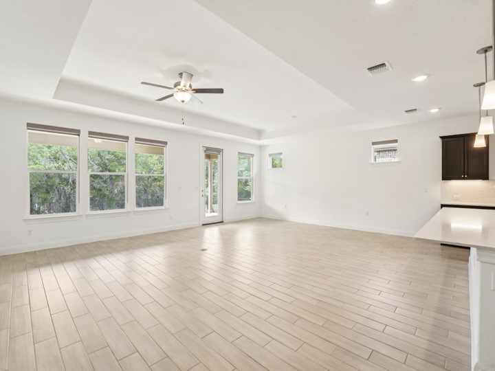312 Kitty Hawk Road Georgetown, TX 78633 - Photo 13 of 37 a view of an empty room with wooden floor and a window