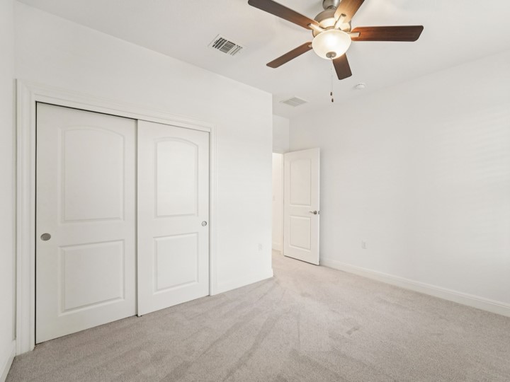 312 Kitty Hawk Road Georgetown, TX 78633 - Photo 17 of 37 an empty room with closet and a chandelier fan
