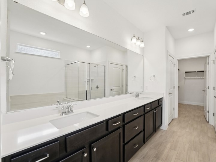 312 Kitty Hawk Road Georgetown, TX 78633 - Photo 20 of 37 a spacious bathroom with a double vanity sink a mirror and a shower
