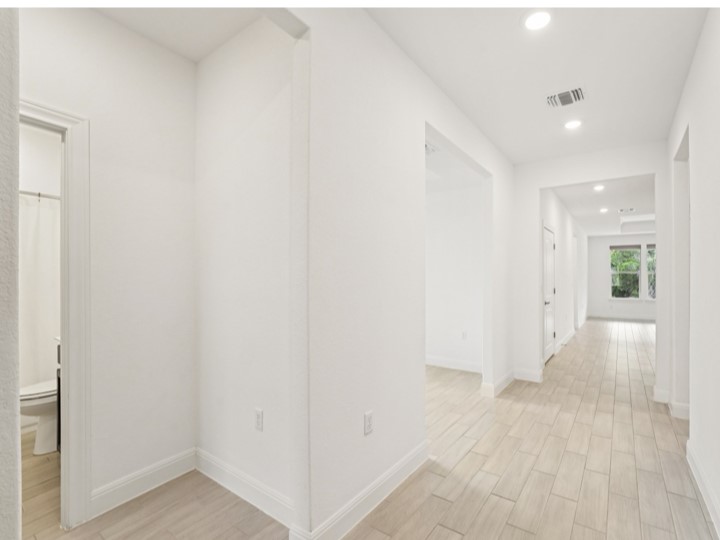 312 Kitty Hawk Road Georgetown, TX 78633 - Photo 22 of 37 a view of a hallway with wooden floor