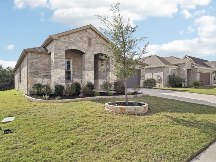 312 Kitty Hawk Road Georgetown, TX 78633 - Photo 3 of 37 a front view of a house with a yard