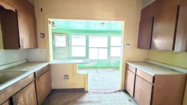 a kitchen with a sink and a large window