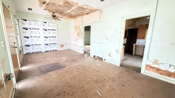 a view of a bedroom with wooden floor and windows