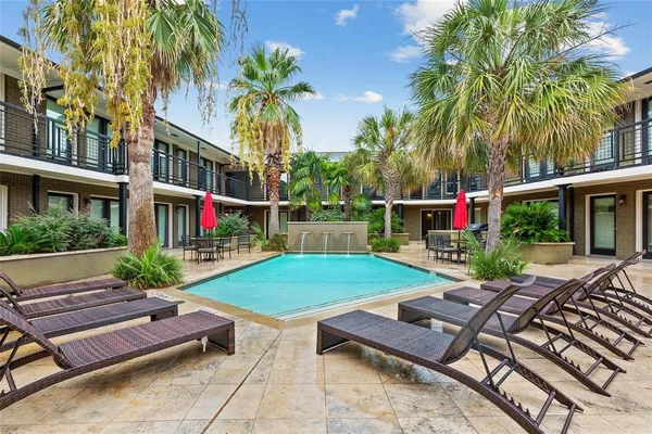 a view of a backyard with sitting area