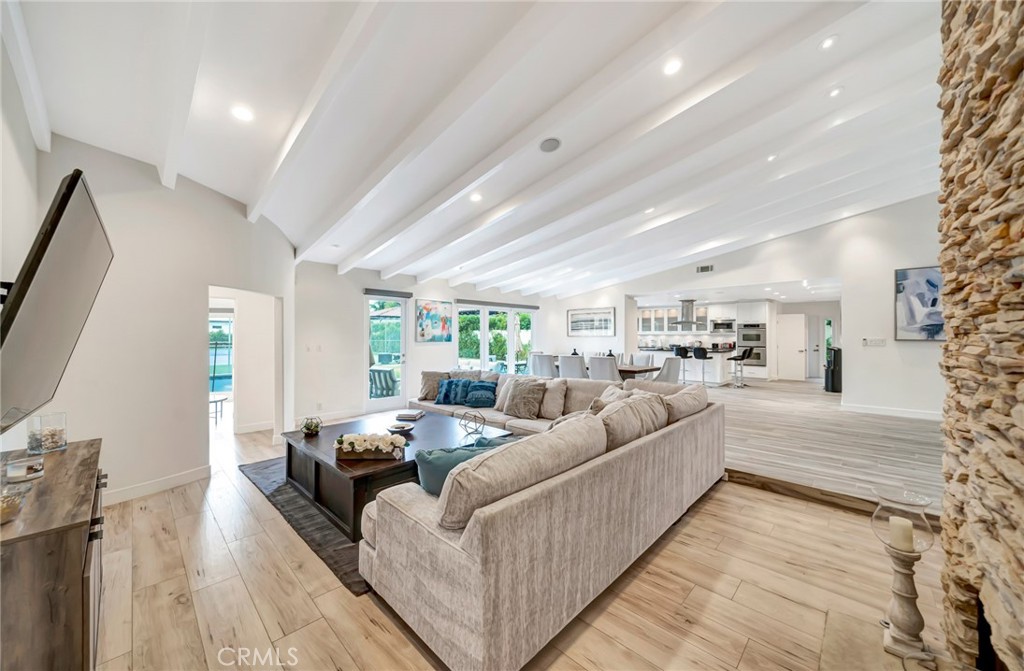 a living room with furniture white walls and a flat screen tv