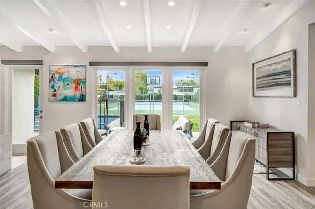 a kitchen with stainless steel appliances kitchen island granite countertop a stove a sink a dining table and chairs