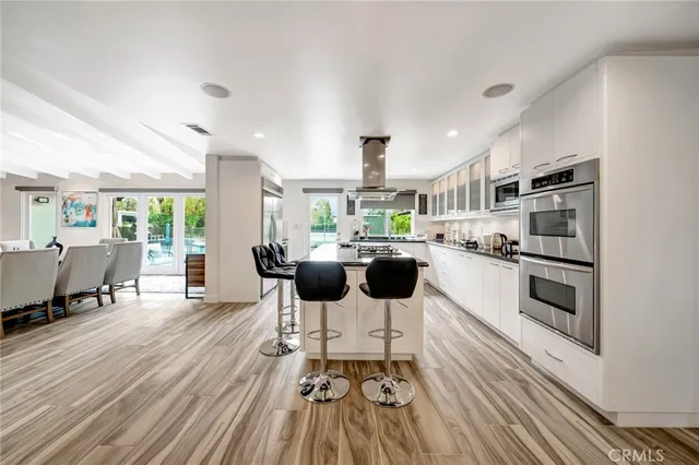a view of a kitchen with a sink cabinets and wooden floor