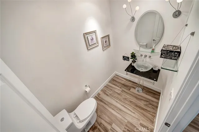 a large bathroom with a sink a toilet and a large mirror